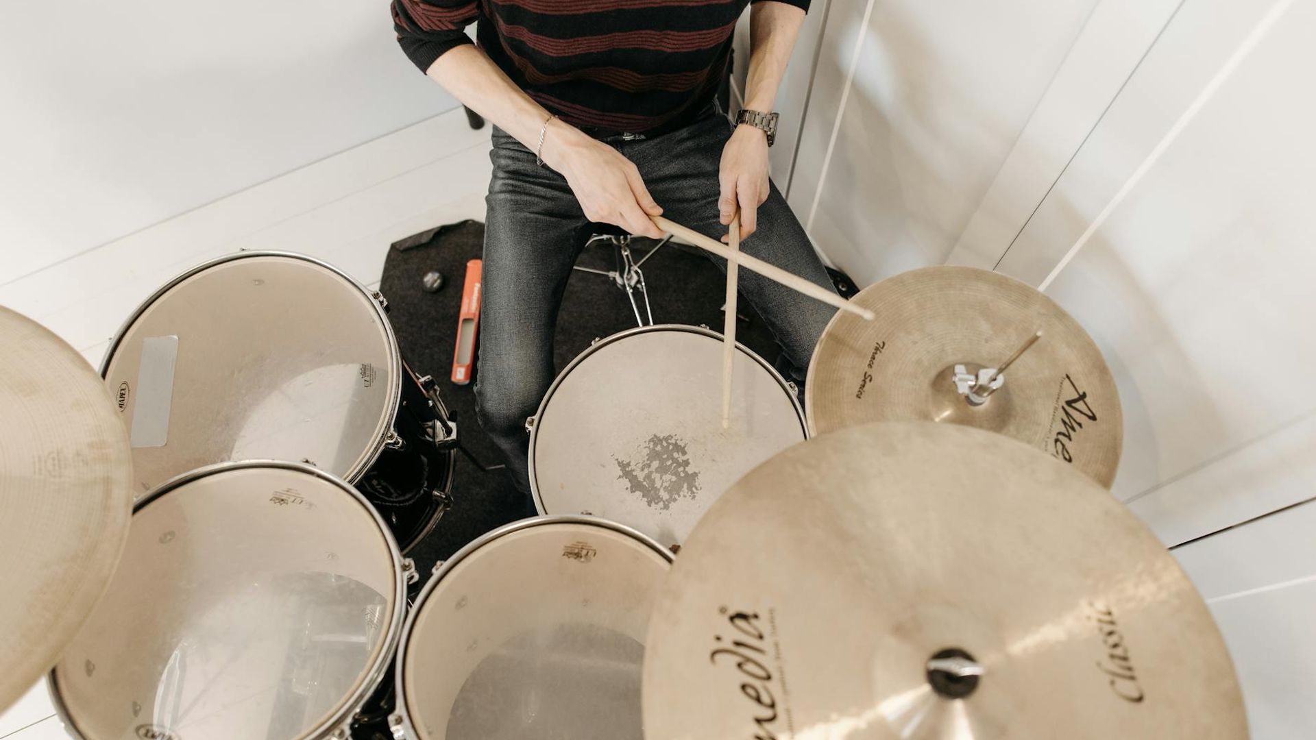 Person practicing rhythmic movements in a bright spacious studio